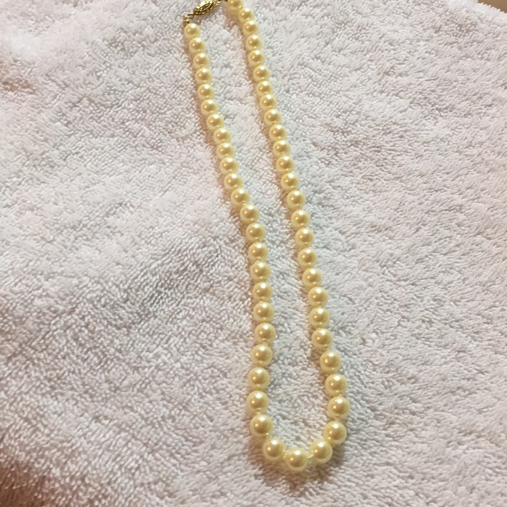 9 inches of string of faux pearls